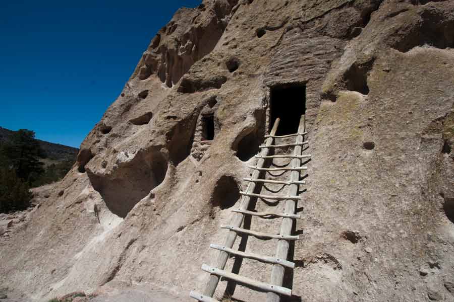 a ladder leading to the cliffside dwellings