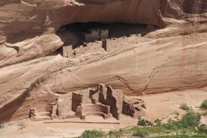 remains of dwellings below and in the cliff