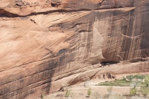 a huge cliff face above the dwelling ruins
