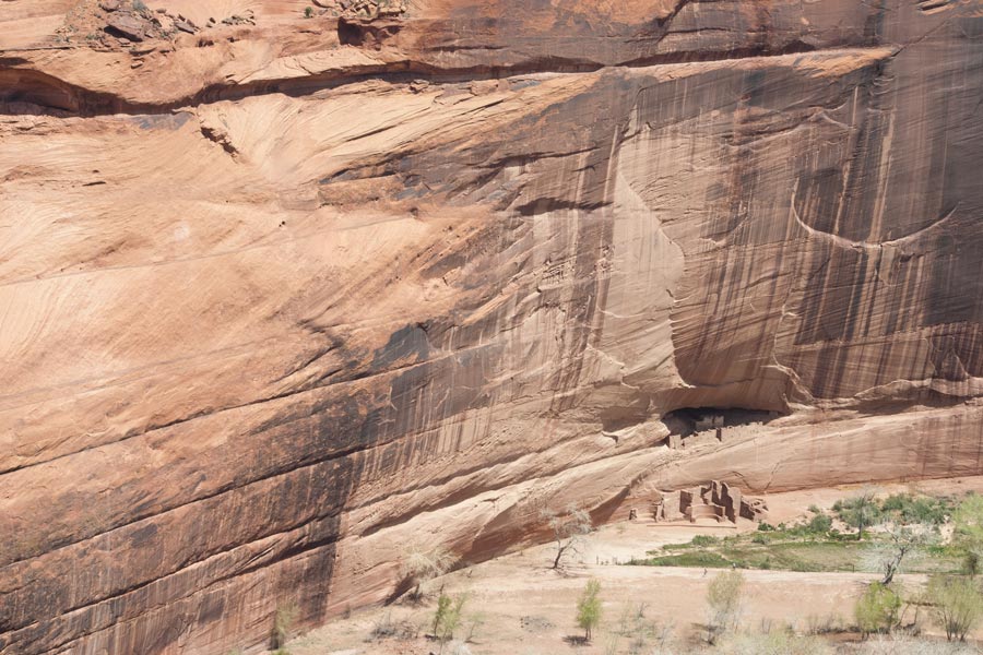 a huge cliff face above the dwelling ruins