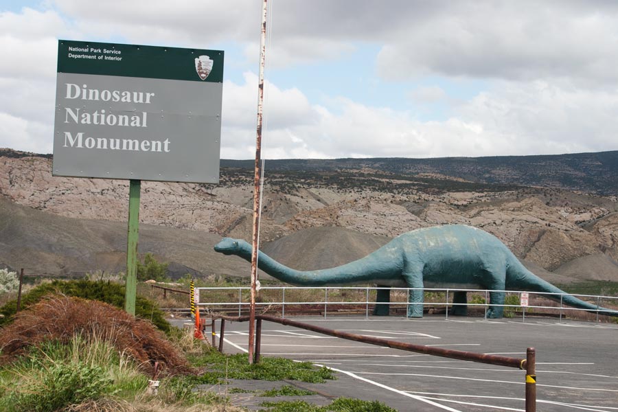 Dinosaur National Monument sign with dino statue in background