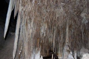 stalactites hang from the cave's ceiling