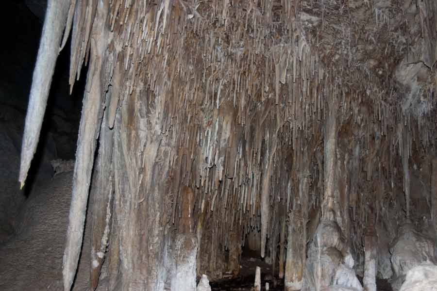 stalactites hang from the cave's ceiling