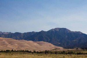 the dunes with a mountain behind them