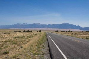 The road leading to the Great Dunes and the mountains behind.