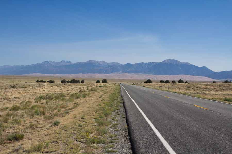The road leading to the Great Dunes and the mountains behind.