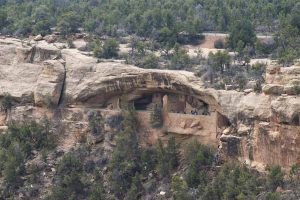 a tour group at the dwellings in the side of a cliff