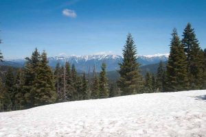 snow on the foreground mountain and the peaks in the background