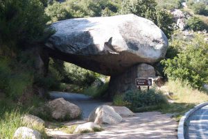 an old road goes under a boulder