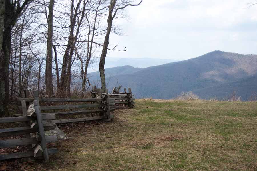 wooden fence leads to mountain view
