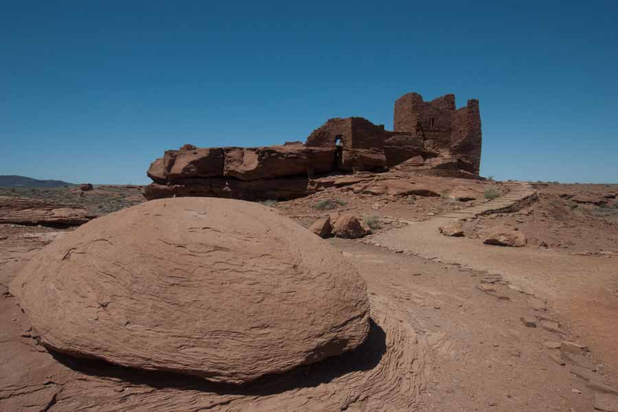 large smooth rock in front of ruins