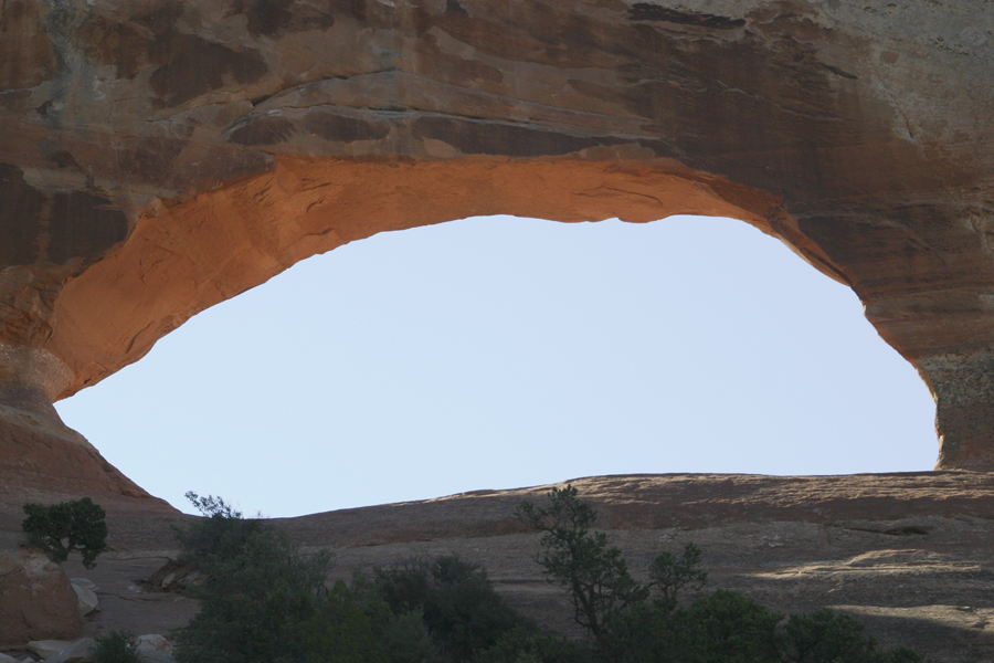 a hole in the rock with sky beyond