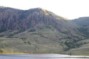 mountain rises above river
