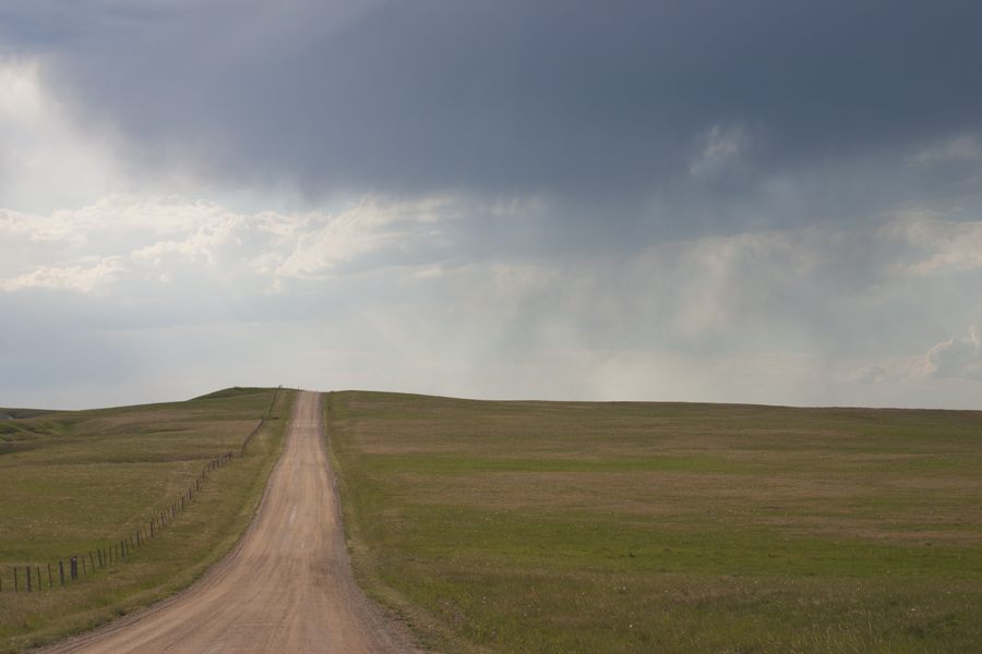 dark cloud above a dirt road