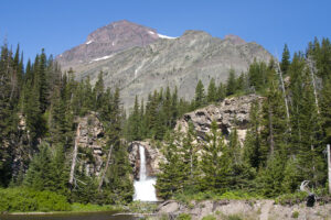 waterfalls with mountain behind