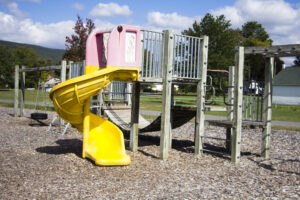 playground with slide, wooden bridge, and monkey bars