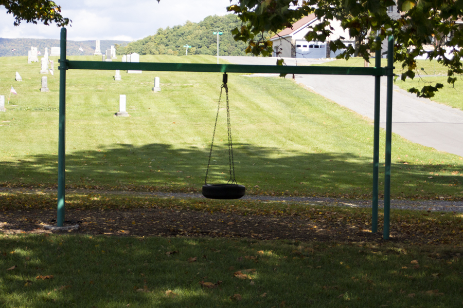 tire swing with cemetery in background