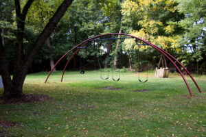 swing set with three regular swings and one toddler swing