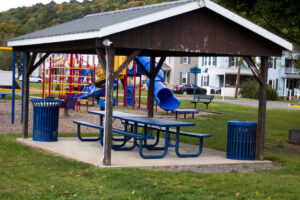 pavilion with two picnic tables and two trash cans