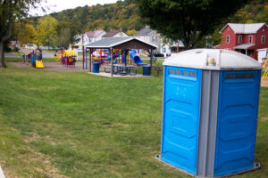 port-a-potty with playground in back