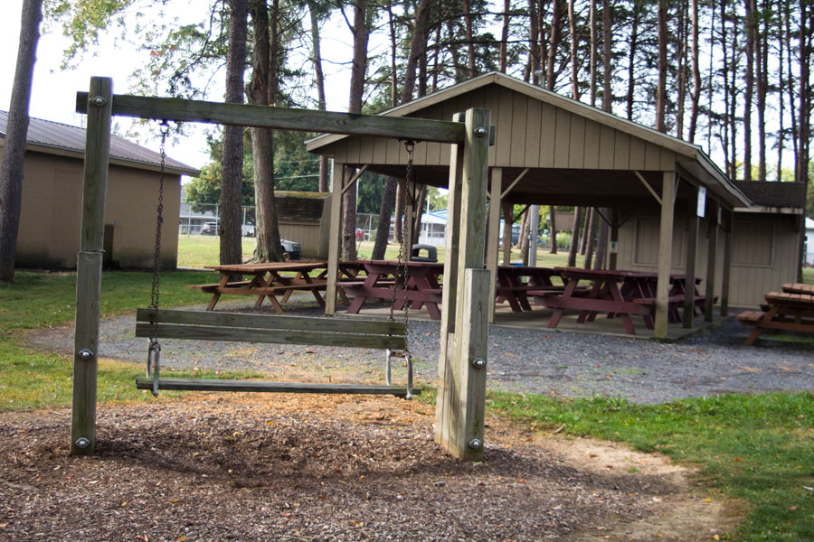 pavilion with picnic tables behind bench swing