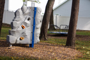 playground rock climbing wall and merry-go-round