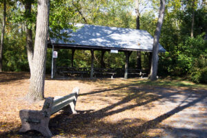 bench in front of pavilion with picnic tables