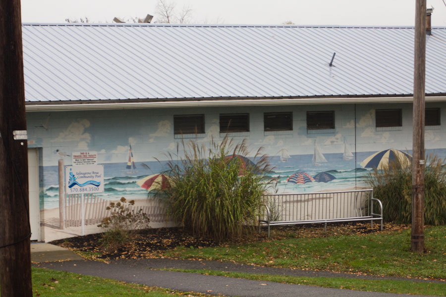 mural on side of building shows beach scene