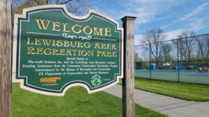 sign for Lewisburg Area Recreation Park with tennis courts behind