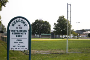 sign for Mifflinburg Community Park with ball field behind