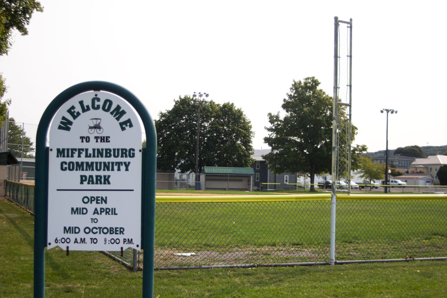 sign for Mifflinburg Community Park with ball field behind