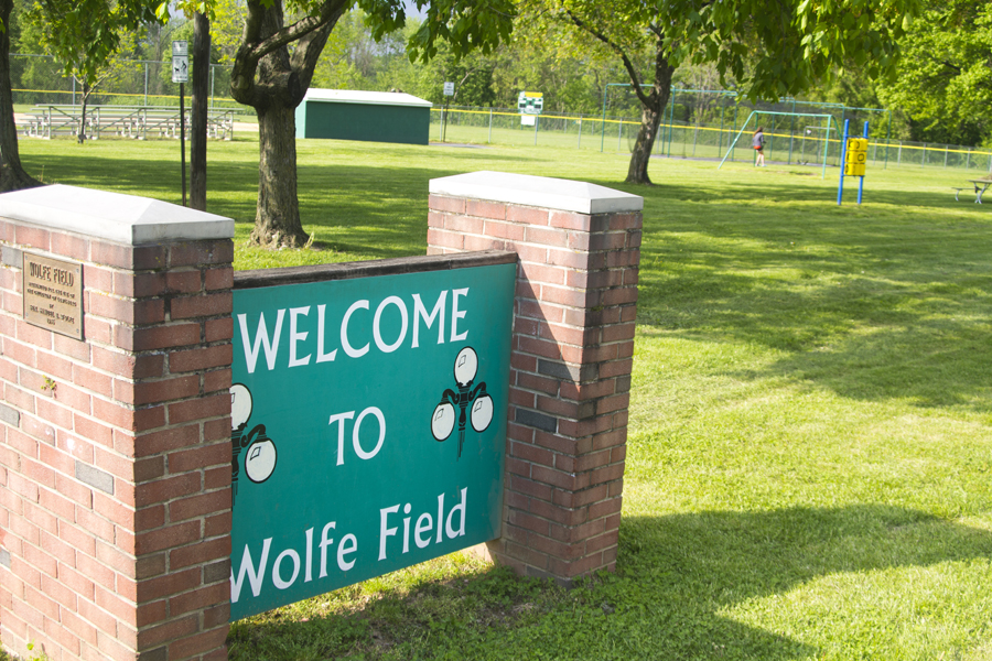 sign for Wolfe Field with playground in background