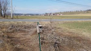birdhouse with farms in background