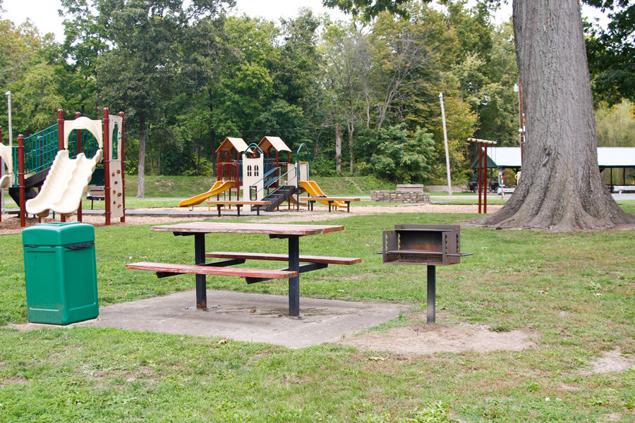 picnic table, grill, trash can, and playground