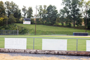 scoreboard on a hill behind ball field