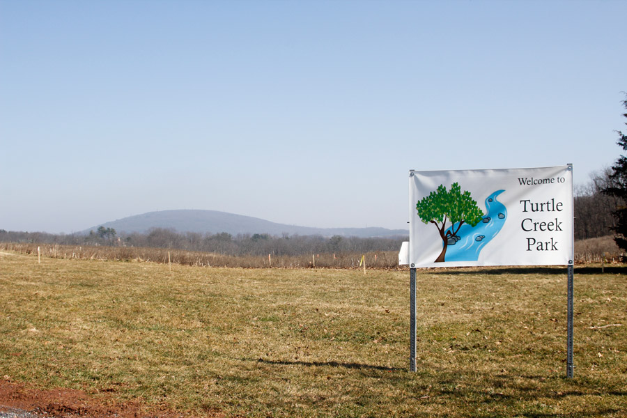 Turtle Creek Park sign with mountain in background