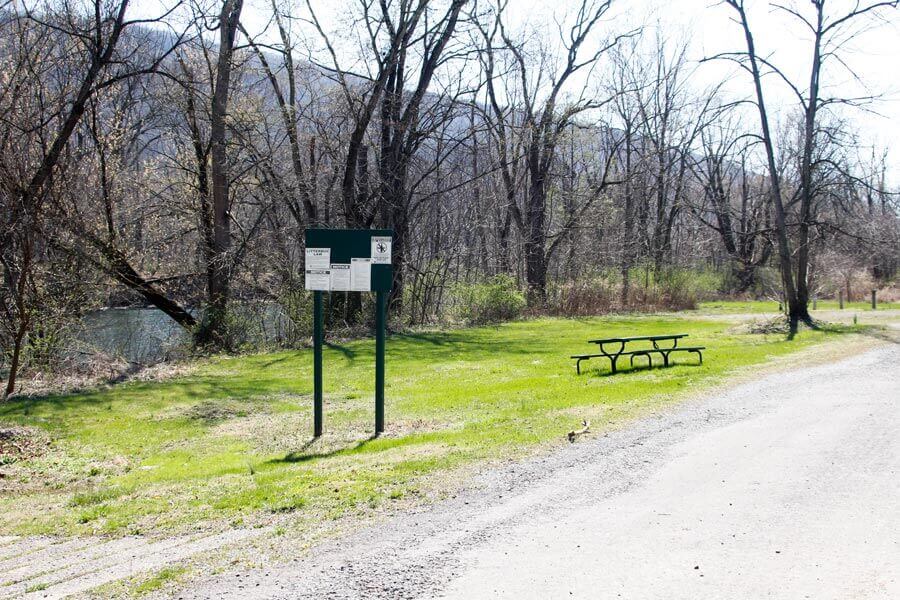 picnic table, sign, and river