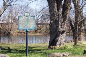 historical marker beside elm tree