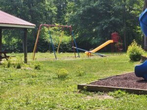 swings, slide, and a see-saw