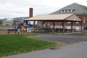 pavilion with picnic tables beside playground