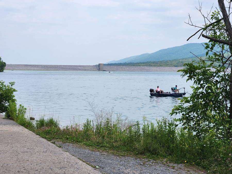 fishing from a boat near the dam