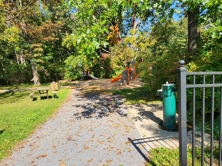water fountain, playground, and picnic table.