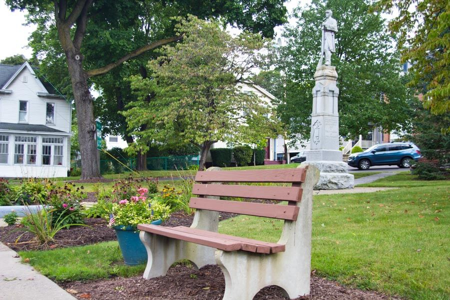 bench with statue behind it