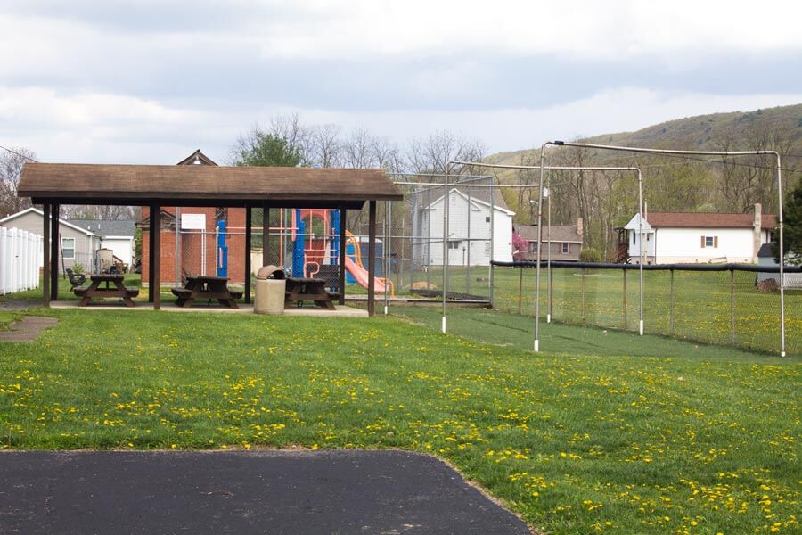 batting cage and pavilion with picnic tables.