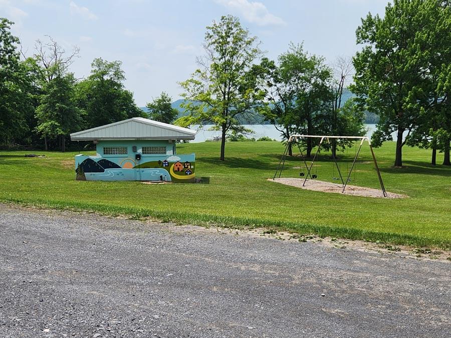 mural on bath house and swings.