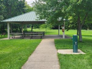 pavilion with picnic tables and water fountain.