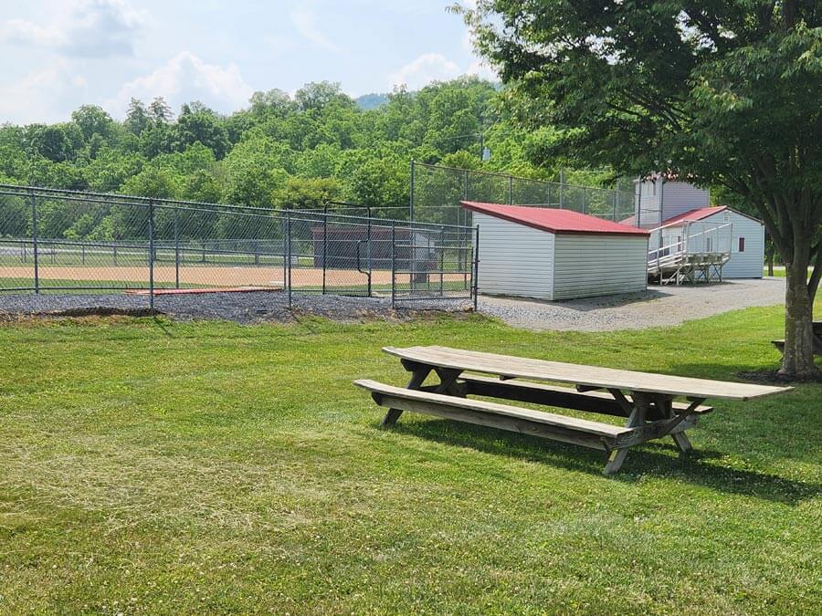 picnic table beside ball field.