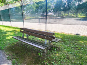 benches beside the tennis court.