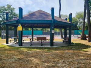 pavilion with two picnic tables and two benches.