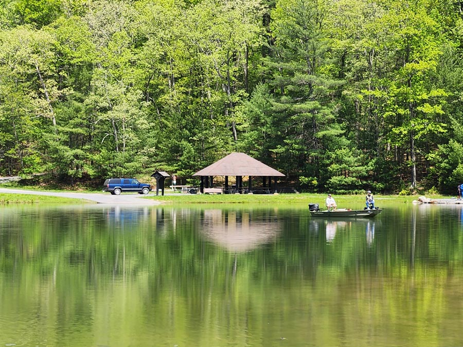 pavilion across the lake and boat on water.